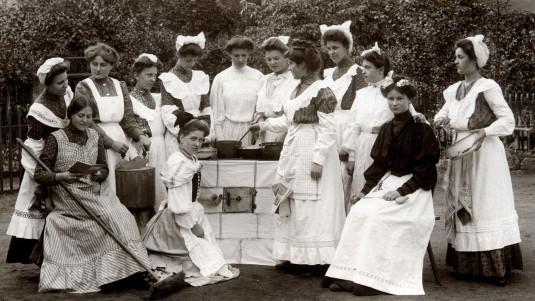 Des domestiques posant autour d'un piano de cuisine